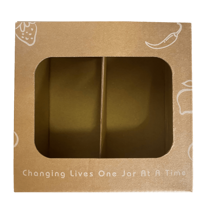 Brown cardboard box with a window displaying a jar, featuring text 'Changing Lives One Jar At A Time'.