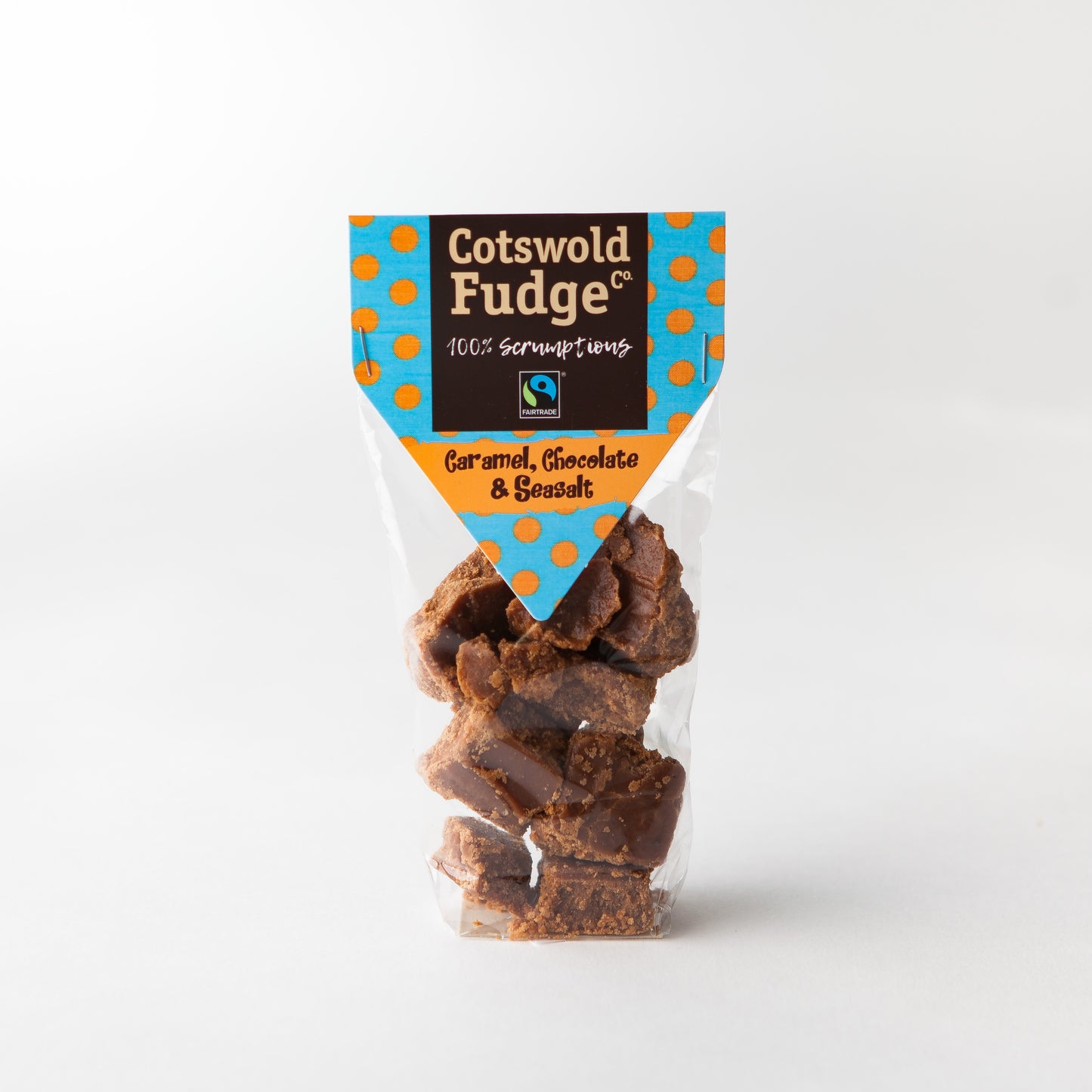 A bag of 100% scrumptious Fairtrade Caramel, Chocolate and Seasalt Fudge made by Cotswold Fudge Co. The bag is transparent with chunks of fudge on display.