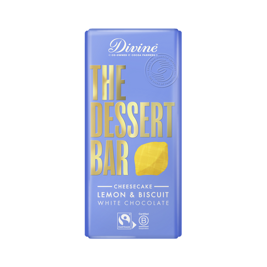 A blue packaging of Divine white chocolate bar with lemon cheesecake flavor, featuring text and an image of a lemon.