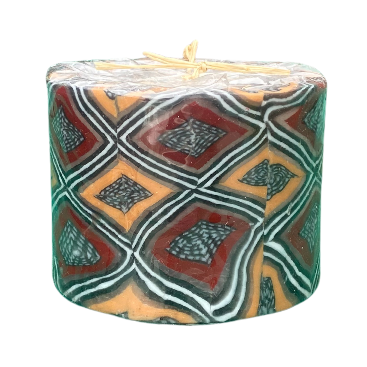 A tealight candle holder with a brown, yellow, black and white African design.
