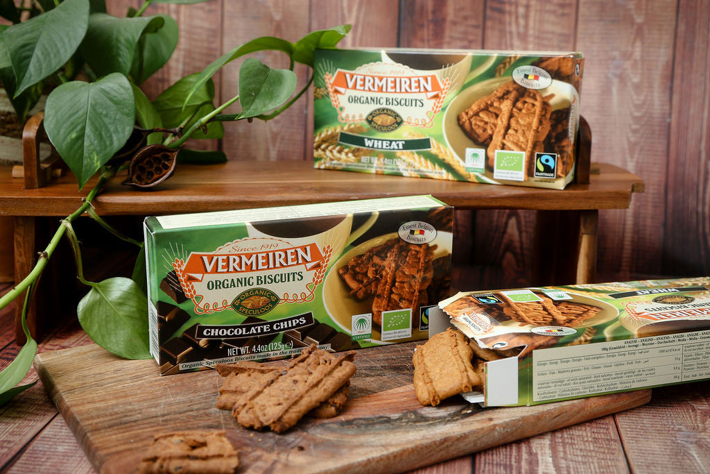 A packet of Fairtrade Vermeiren organic wheat and choc chip biscuits from Belgium next to an open packet with some loose biscuits falling out.