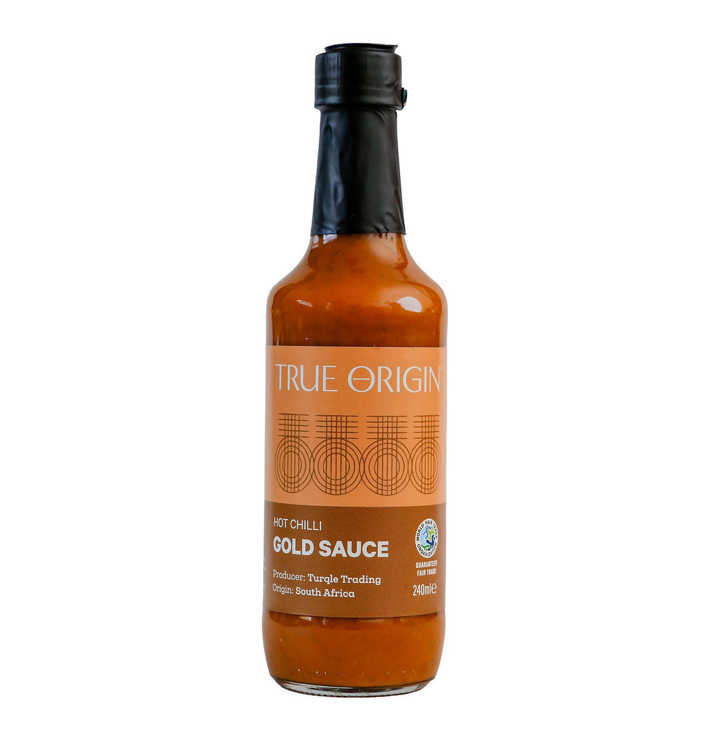 Bottle of True Origin Gold Sauce on a white background