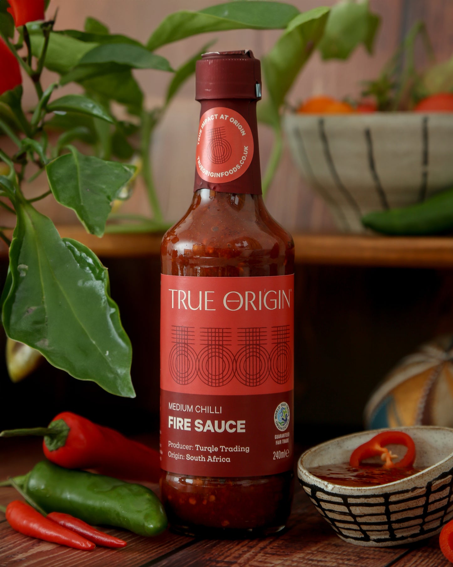 A bottle of True Origin Medium Chilli Fire Sauce with medium chilli, indicating medium spiciness level.