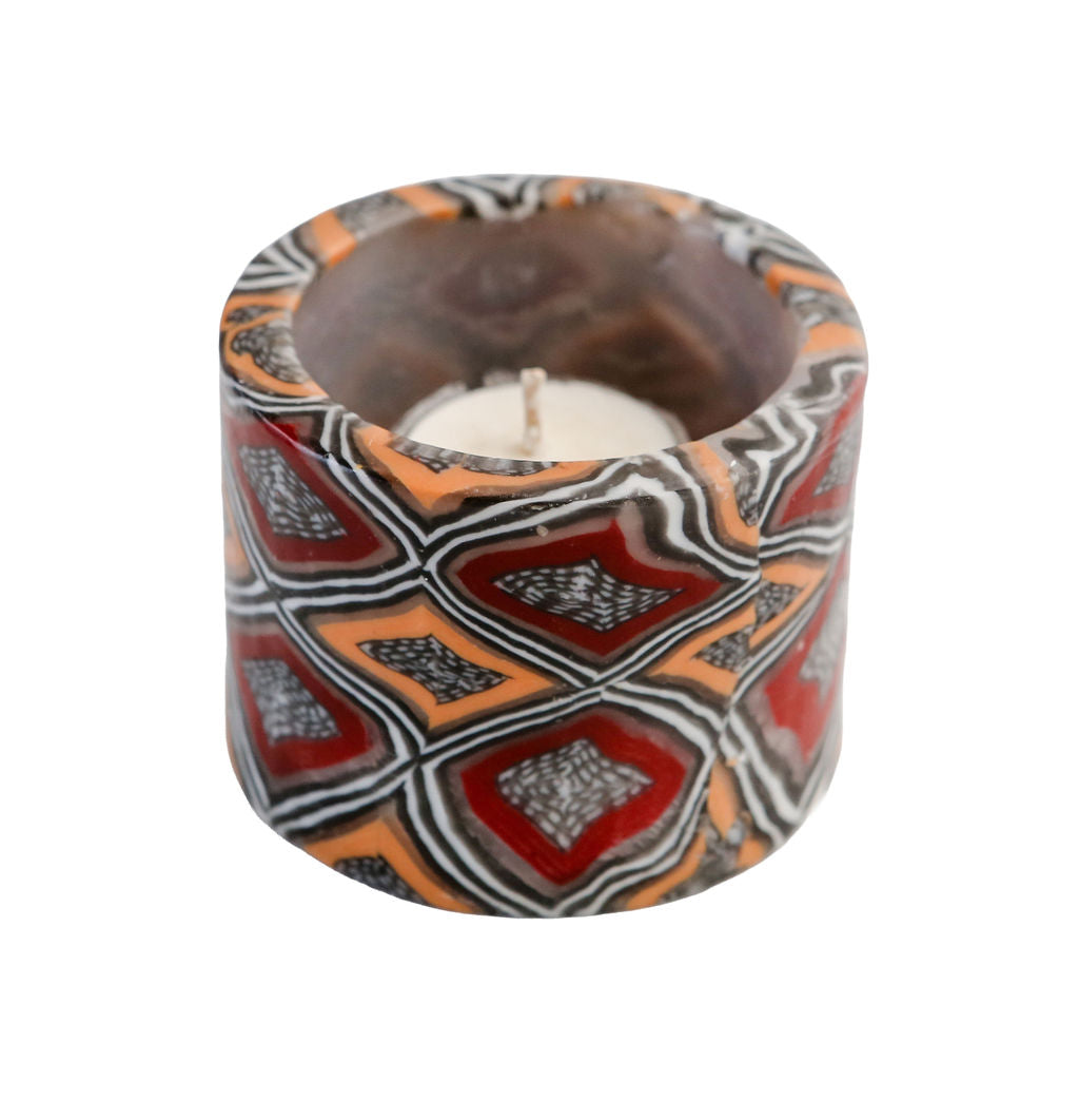 Decorative tealight candle holder with geometric pattern on a white background