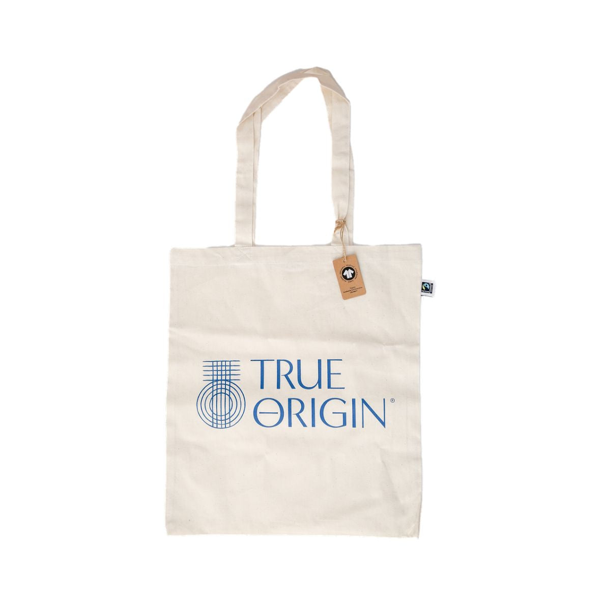 A cream Fairtrade cotton tote bag with the blue stacked True Origin logo with some True Origin products sticking out the top.