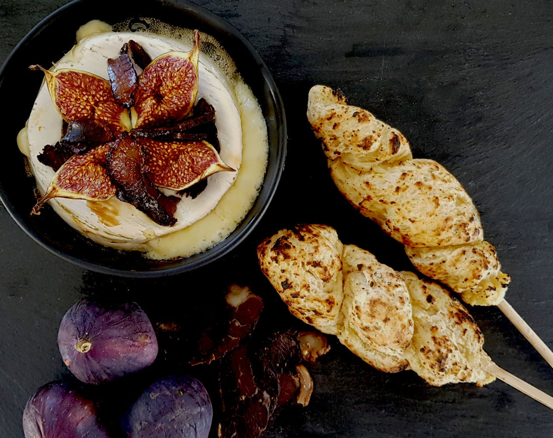 Barbecued bread on a stick with melted brie & fig dip