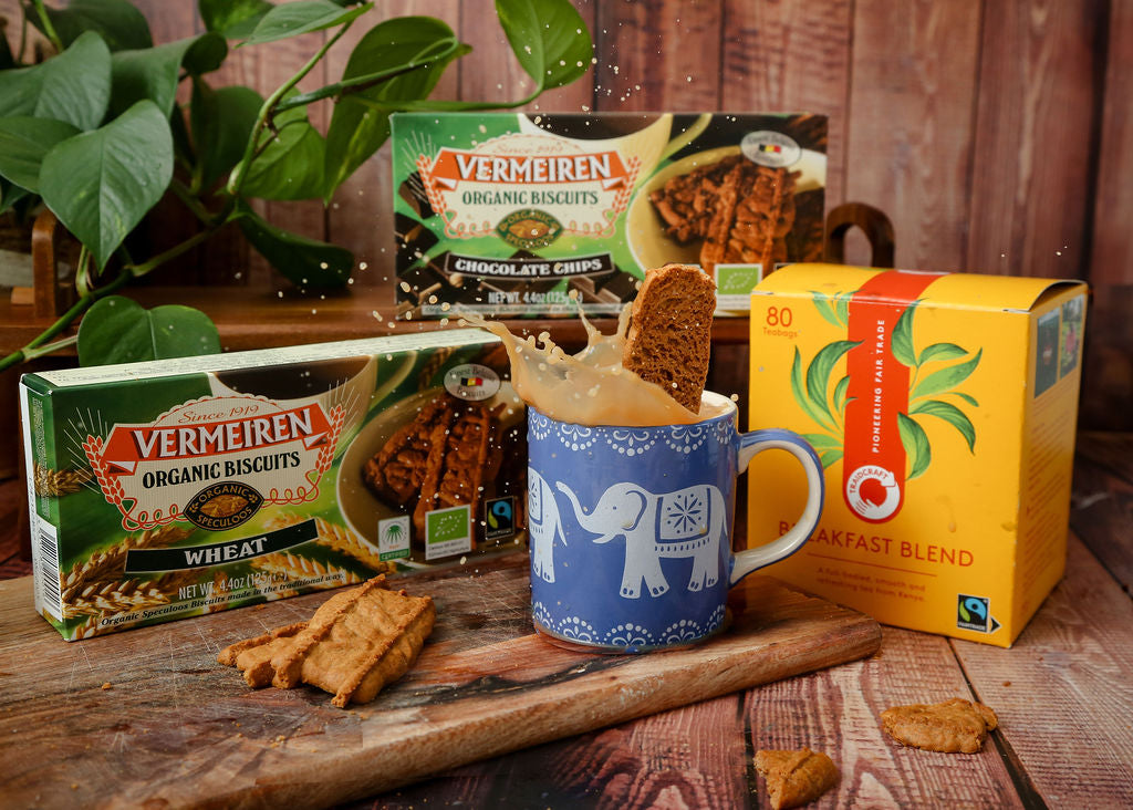 Traidcraft Fairtrade Tea, Vermeiren Organic Biscuits (both wheat and chocolate chip) and a blue mug with a white elephant design with tea in it and a biscuit being dunked.