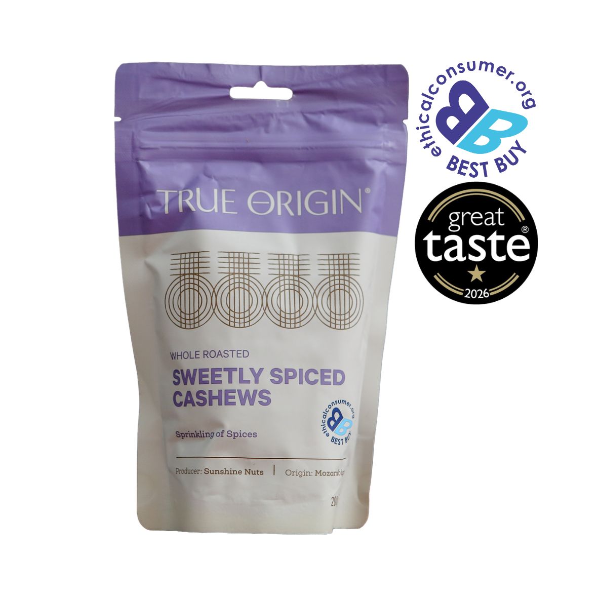 A stand-up pouch of True Origin Sweetly Spiced Cashews on a white background, with a purple top section and cream lower section. Two award badges are displayed on the top right: The Best Buy Logo and 1 star Great Taste Award 2026.