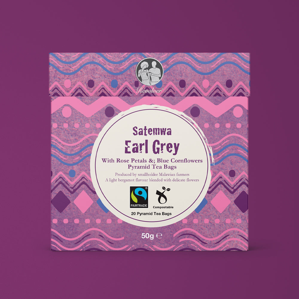 A lilac patterned box of Fairtrade Satemwa Earl Grey tea on a purple background.
