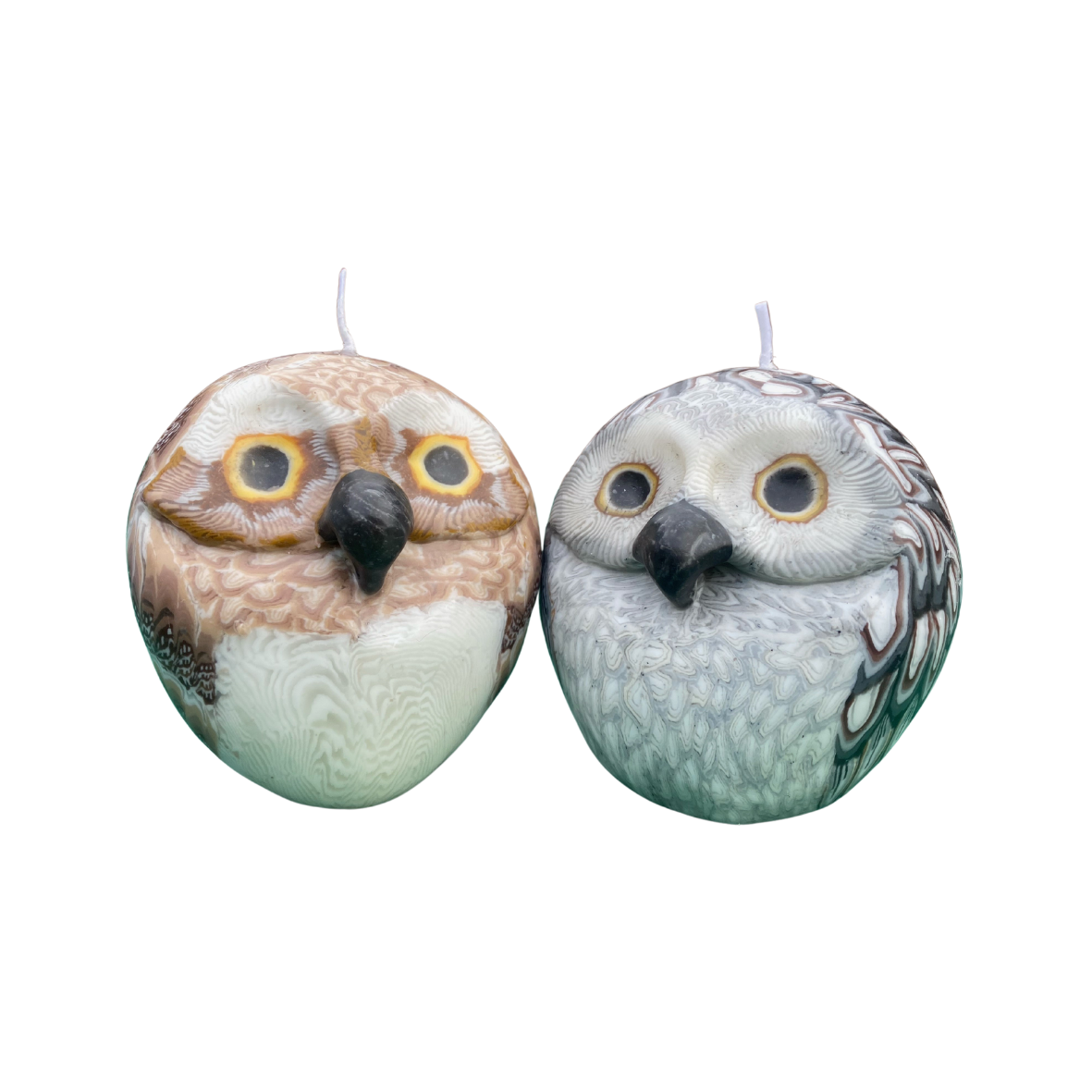 A brown and a grey round owl candles on a white background.