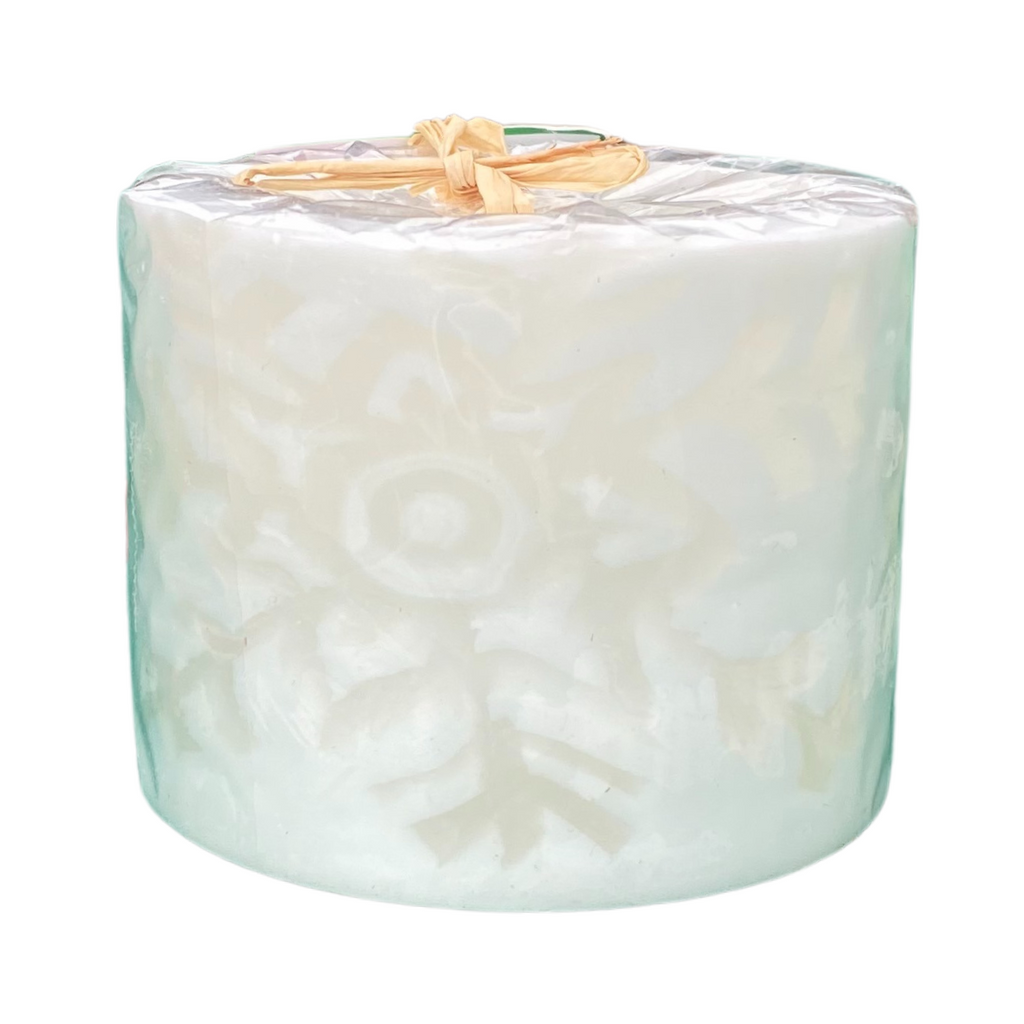 A white tealight holder with a snowflake design.  