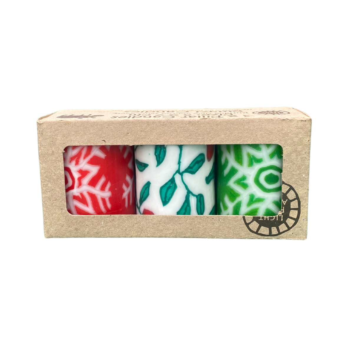A triple pack of church candles with a Christmas design.  The is a red candles with a white snowflake design, a white candle with a holly design and a green candle with a white snowflake design.