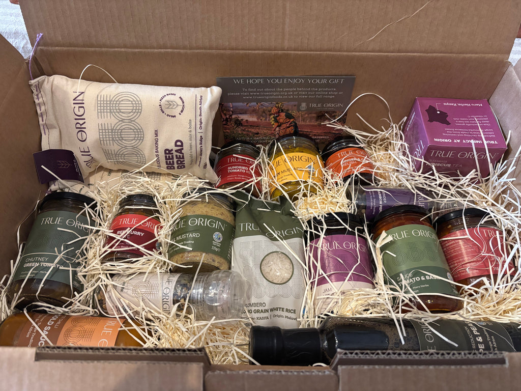 Open Foodie Selection Hamper box containing various packaged goods including condiments, herbal tea and more.