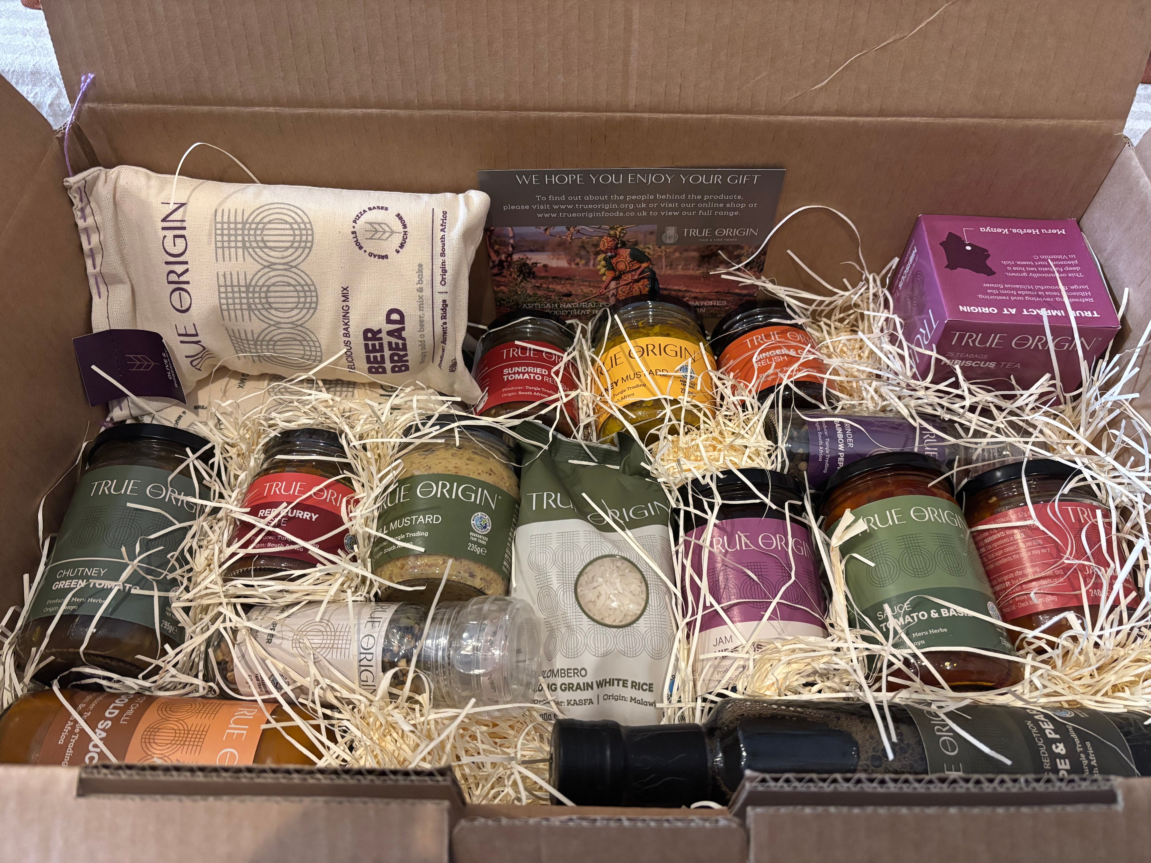 Open Foodie Selection Hamper box containing various packaged goods including condiments, herbal tea and more.
