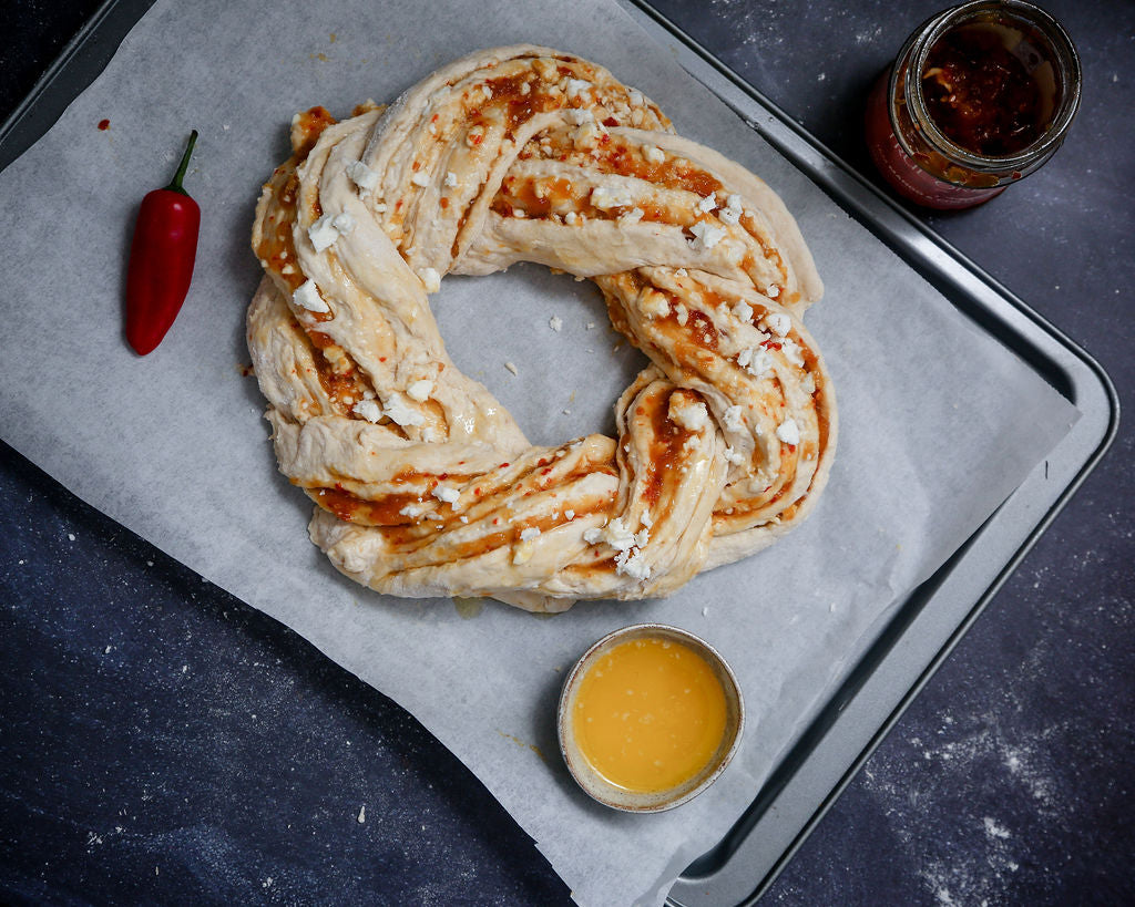 A recipe using chilli and garlic beer bread and mango and chilli jam to make a Christmas wreath bread.