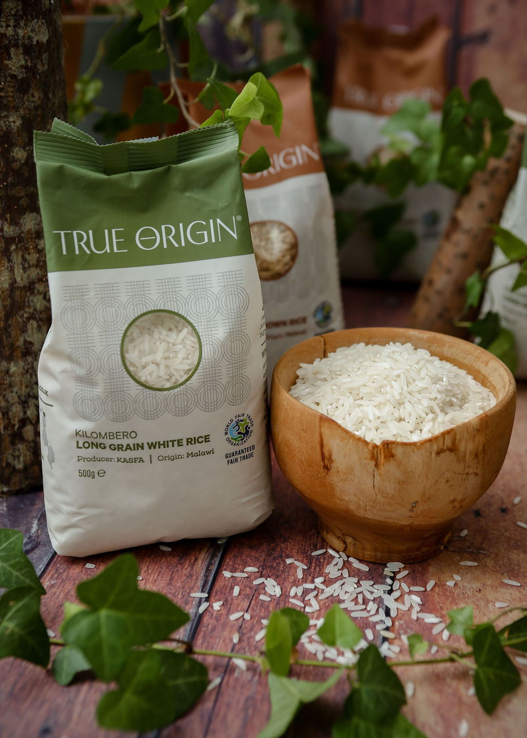 A bag of Kilombero white long grain aromatic rice next to a bowl containing the raw rice grains.