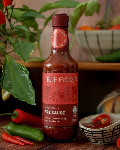 A bottle of True Origin Medium Chilli Fire Sauce with medium chilli, indicating medium spiciness level.