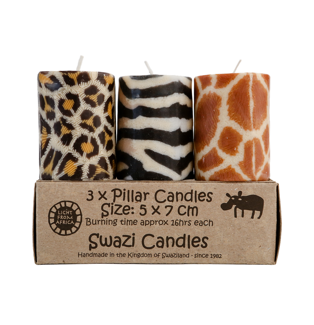 Three animal print candles in a cardboard box labeled 'Swazi Candles'.