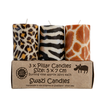 Three animal print candles in a cardboard box labeled 'Swazi Candles'.
