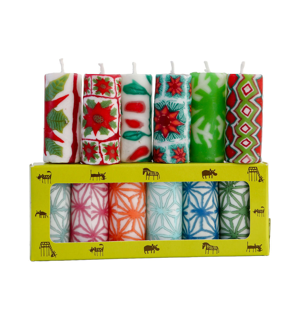 Set of 6 festive and 6 web patterned candles in a yellow box on a white background