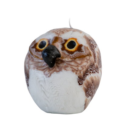 Decorative owl-shaped candle with a white and brown pattern on a transparent background