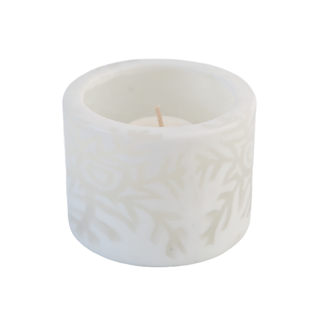 White snowflake tealight candle holder containing an unlit candle on a transparent background