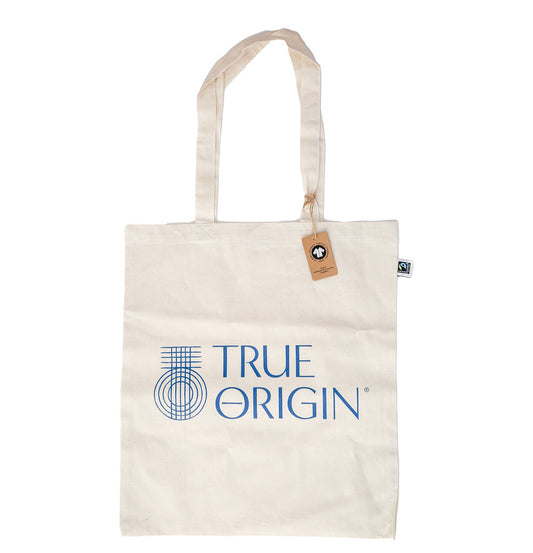 A beige cotton tote bag with 'TRUE ORIGIN' branding and a logo on the front.