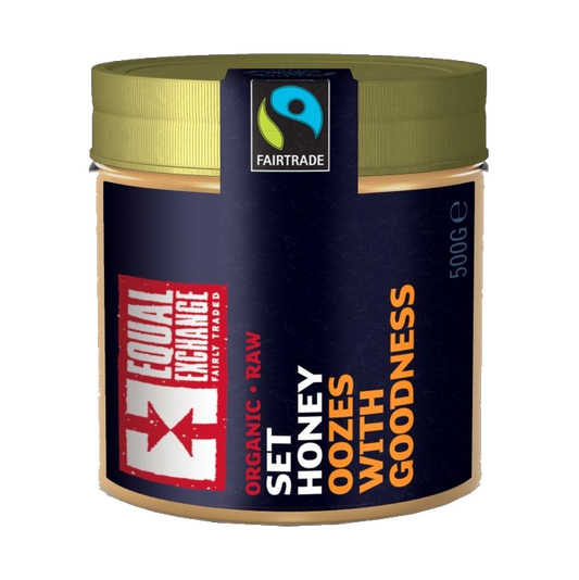 A jar of Equal Exchange organic raw set honey, 500g size, with Fair Trade certification logo.
