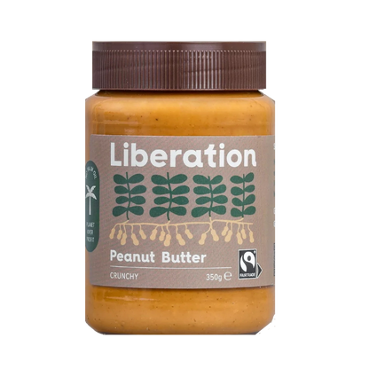 A jar of Liberation Foods Fairtrade Peanut Butter, crunchy type, with a label showing the brand name and a graphic of peanuts. The jar size is 350g.