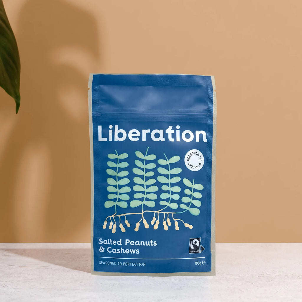A blue bag of fair trade Liberation Foods salted peanuts and cashew nuts.